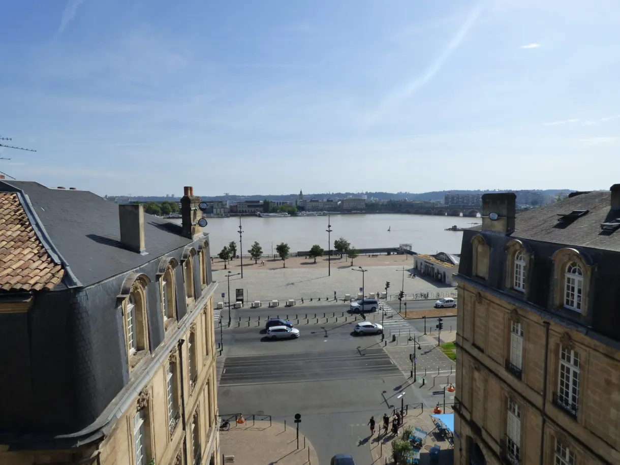 Toits d'ardoise et esplanade au bord de l'eau depuis une fenêtre haute