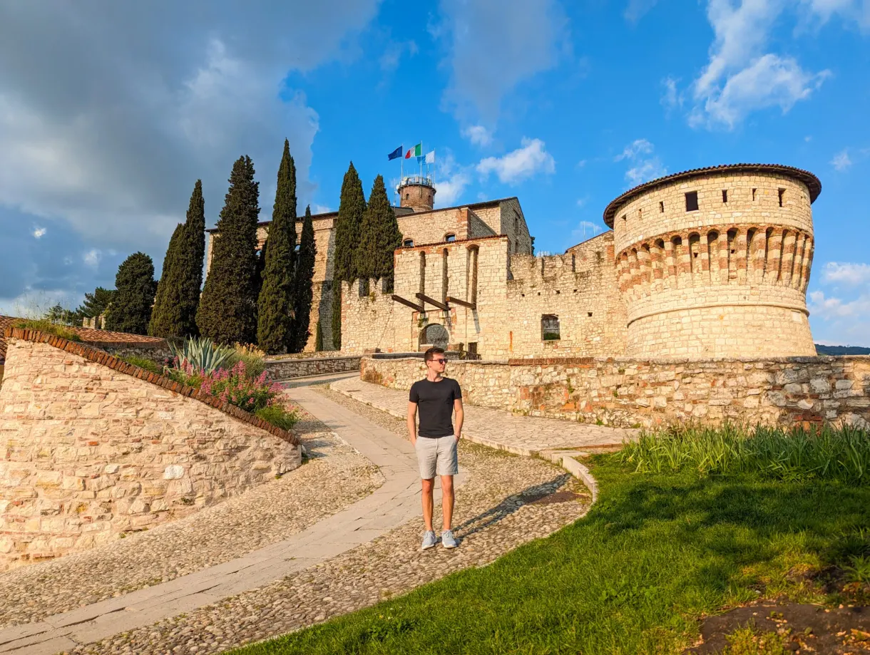Traveller on the cobbled ramp climbing to the castle of Brescia