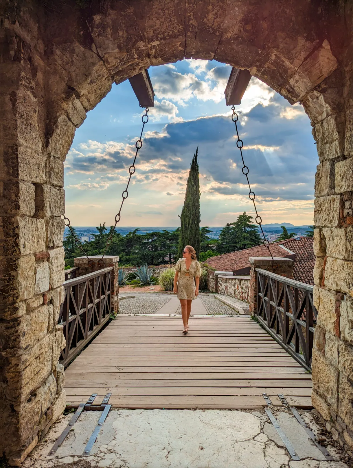 Passer-by crossing the drawbridge seen beneath the arch