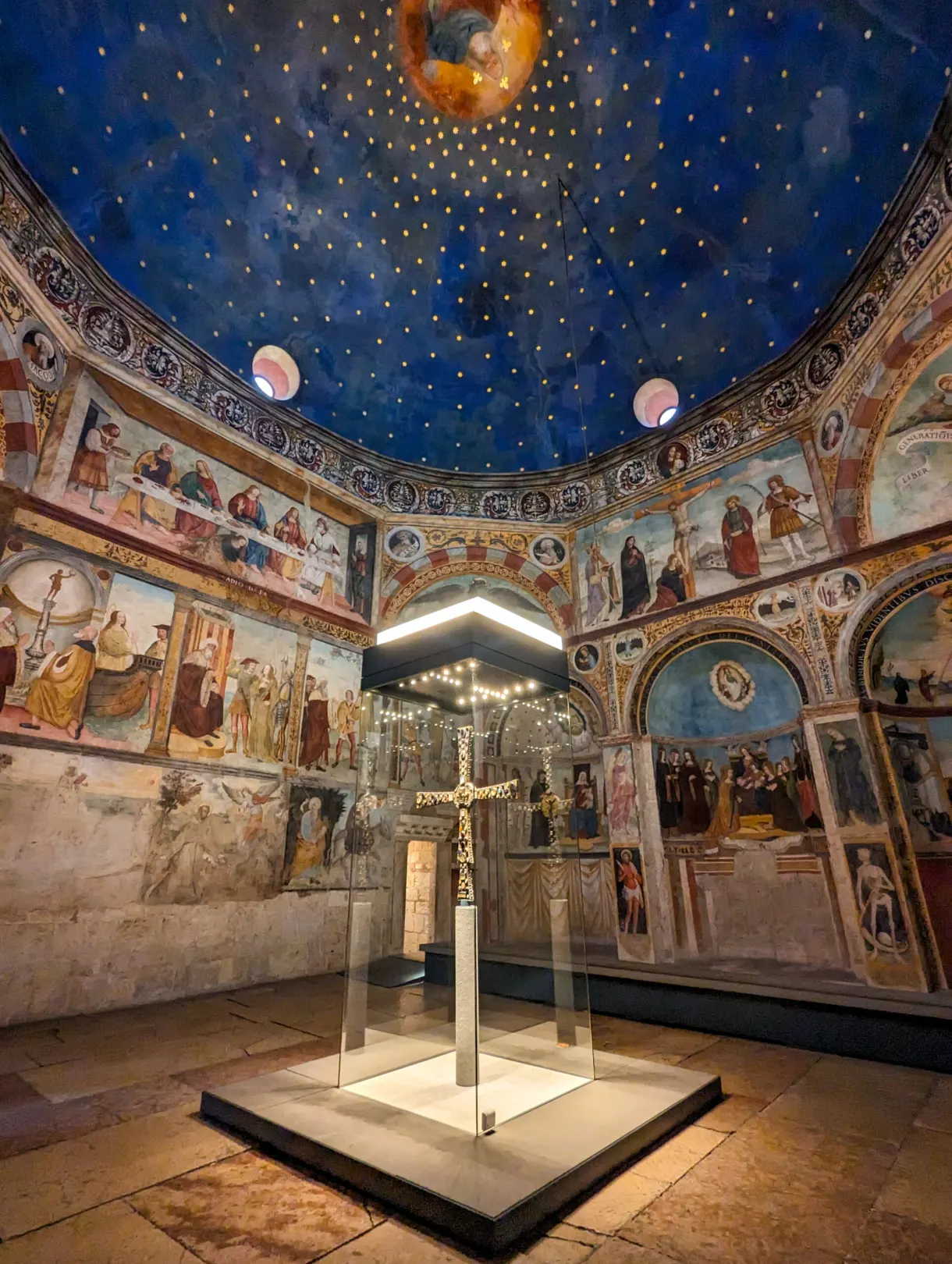 Medieval cross on show beneath a blue starred vault