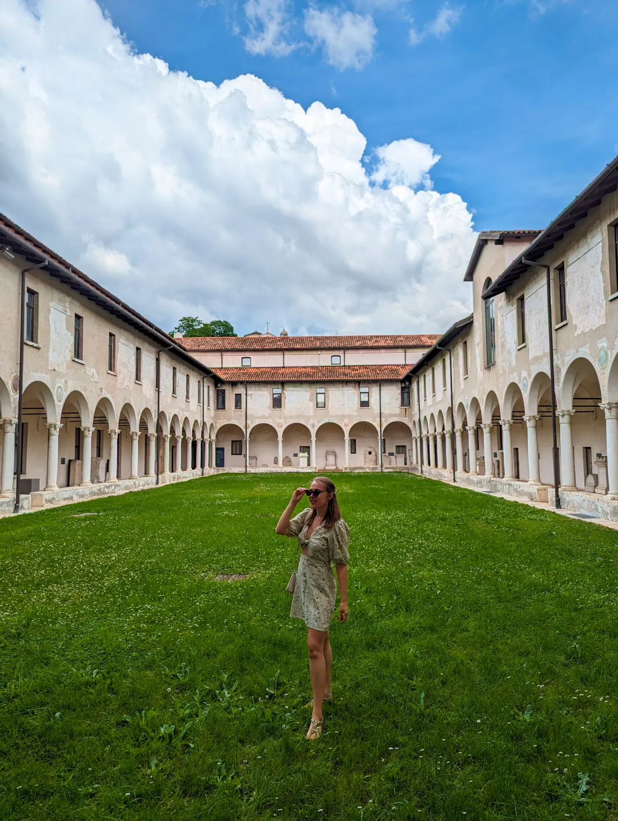 Visitor taking photographs from the cloister lawn