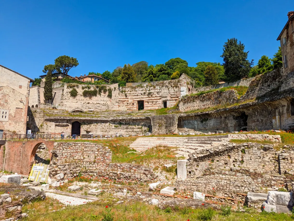 Tiers and ruins of the Roman theatre overgrown with grass