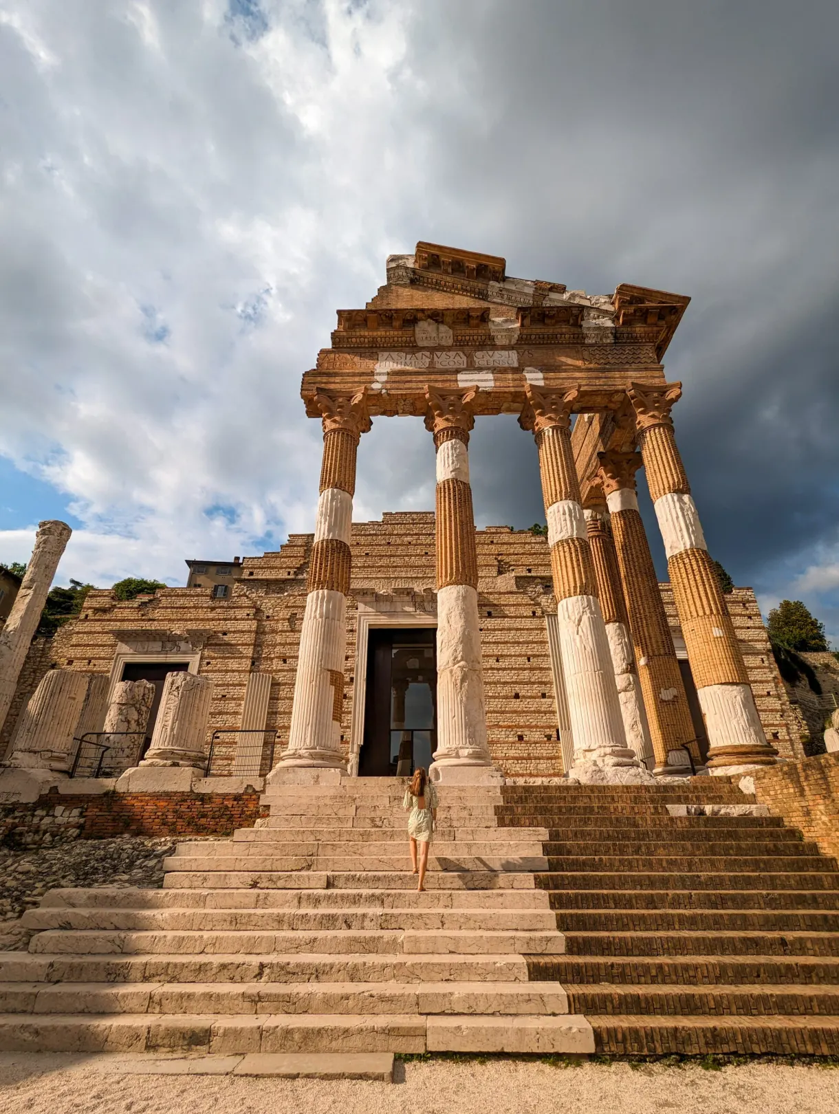 Capitoline temple and its staircase under a cloudy sky
