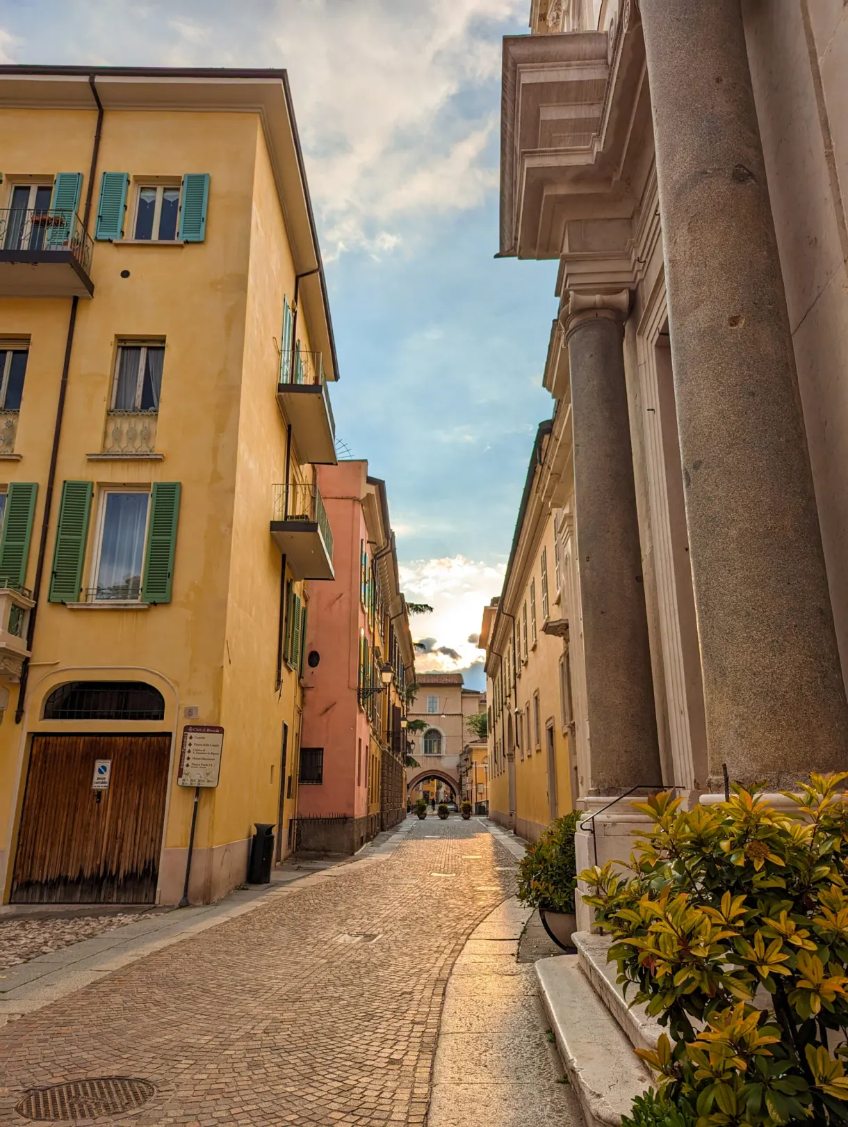 Street with pastel houses framed by a column