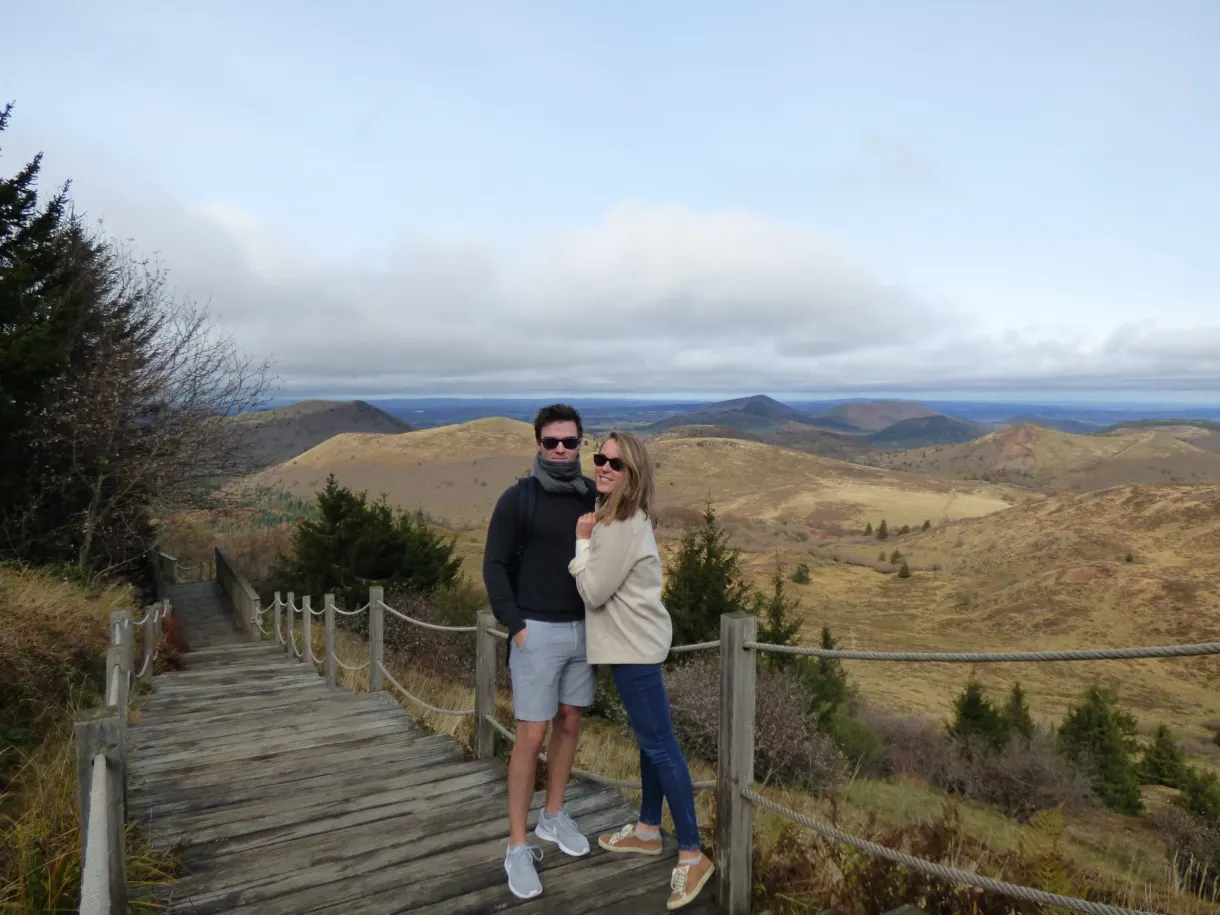 Couple posing on the steps facing the volcanoes