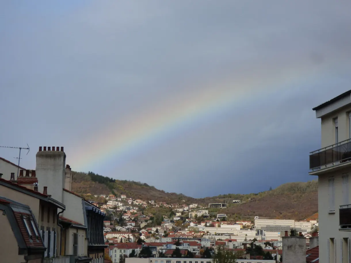 Rainbow above the rooftops of the city