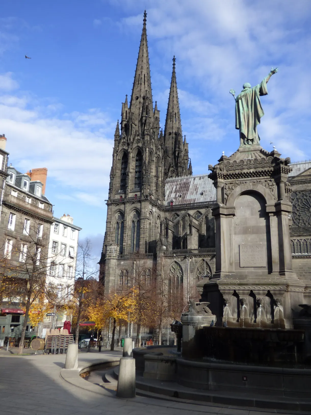Dark spires towering over a pale stone monument