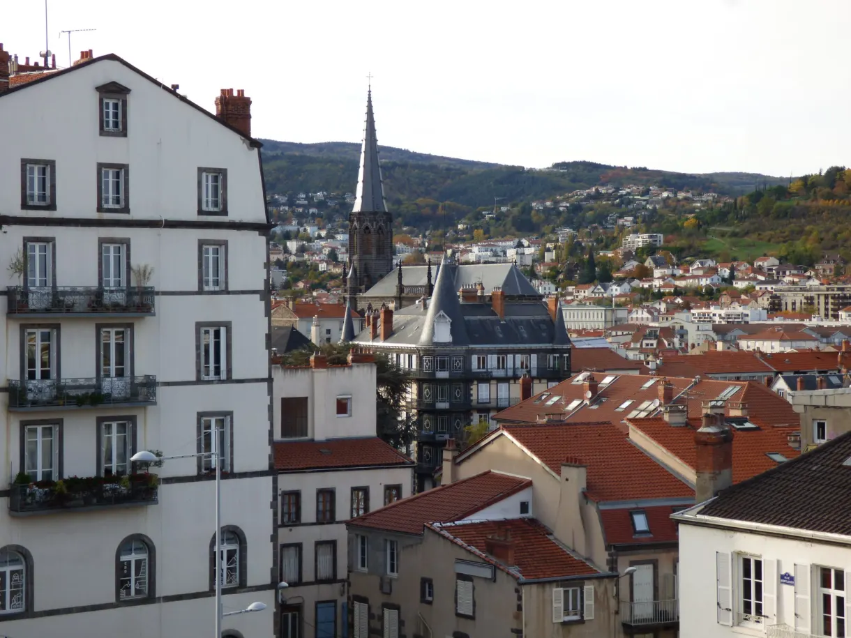 View over the rooftops and a bell tower from a balcony