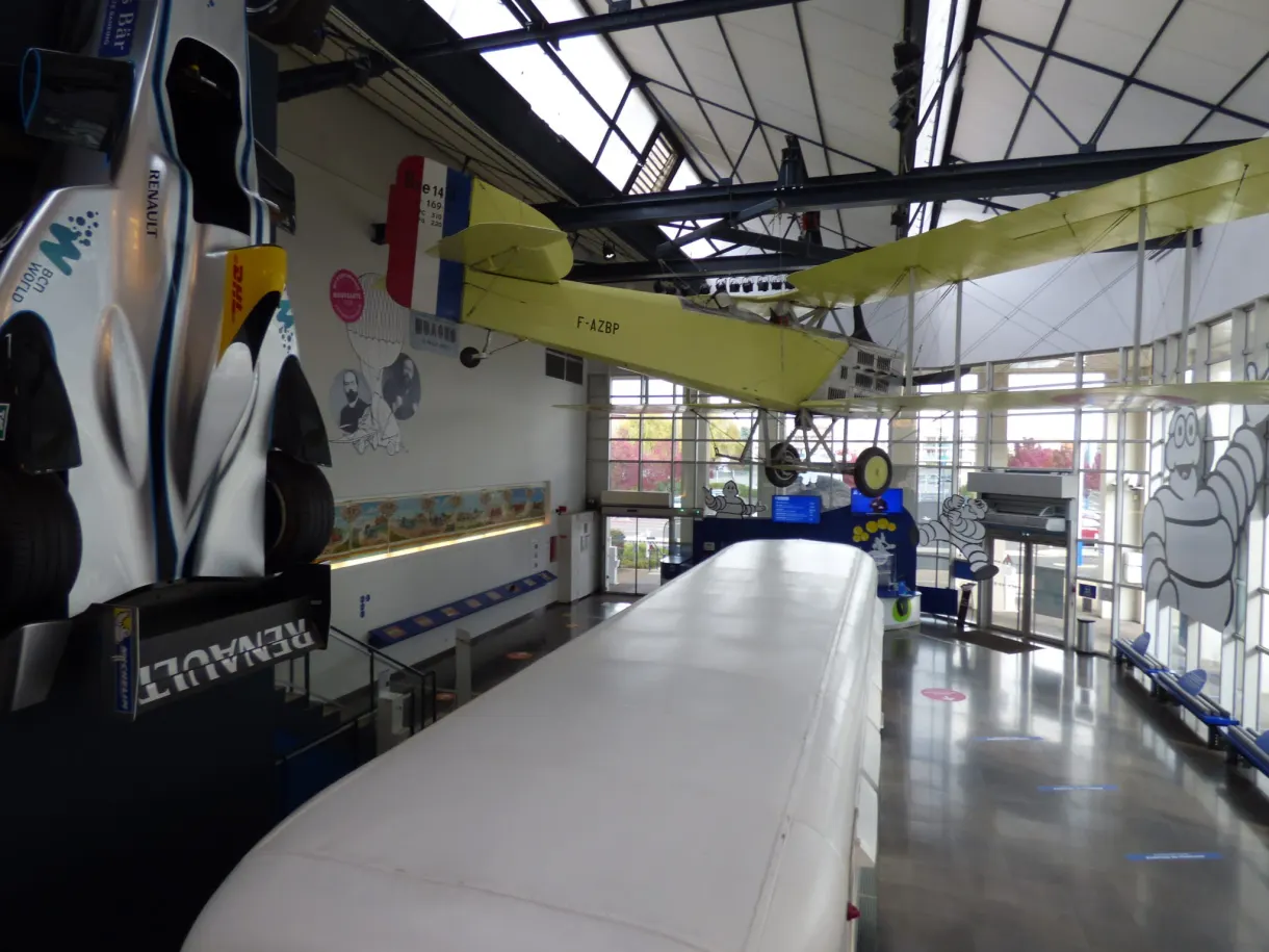 Yellow aeroplane suspended in the glass hall of the museum