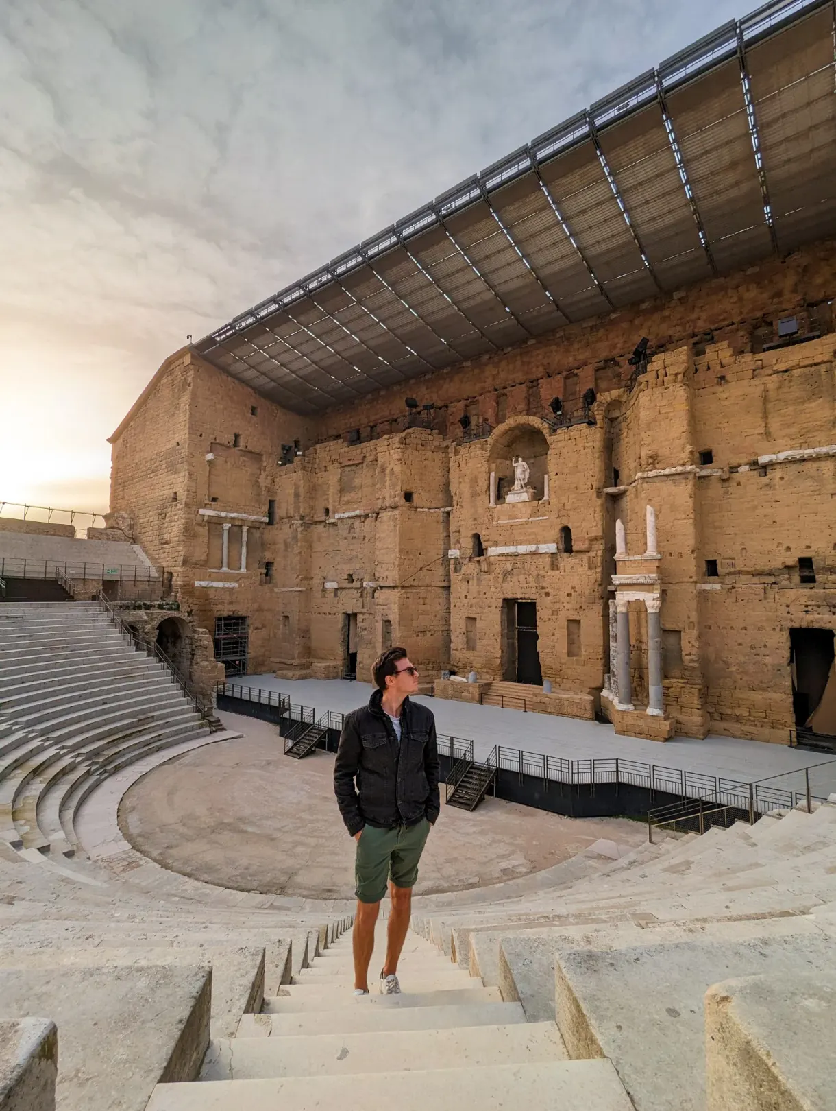 Romain on the tiers of the ancient theatre in Orange, facing the Roman stage wall