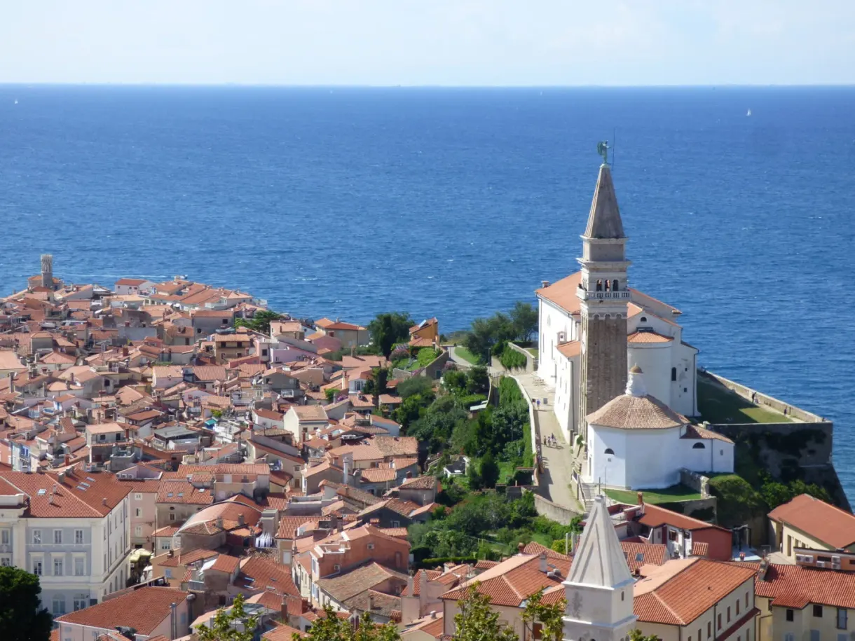 Tiled roofs packed around the church and its bell tower