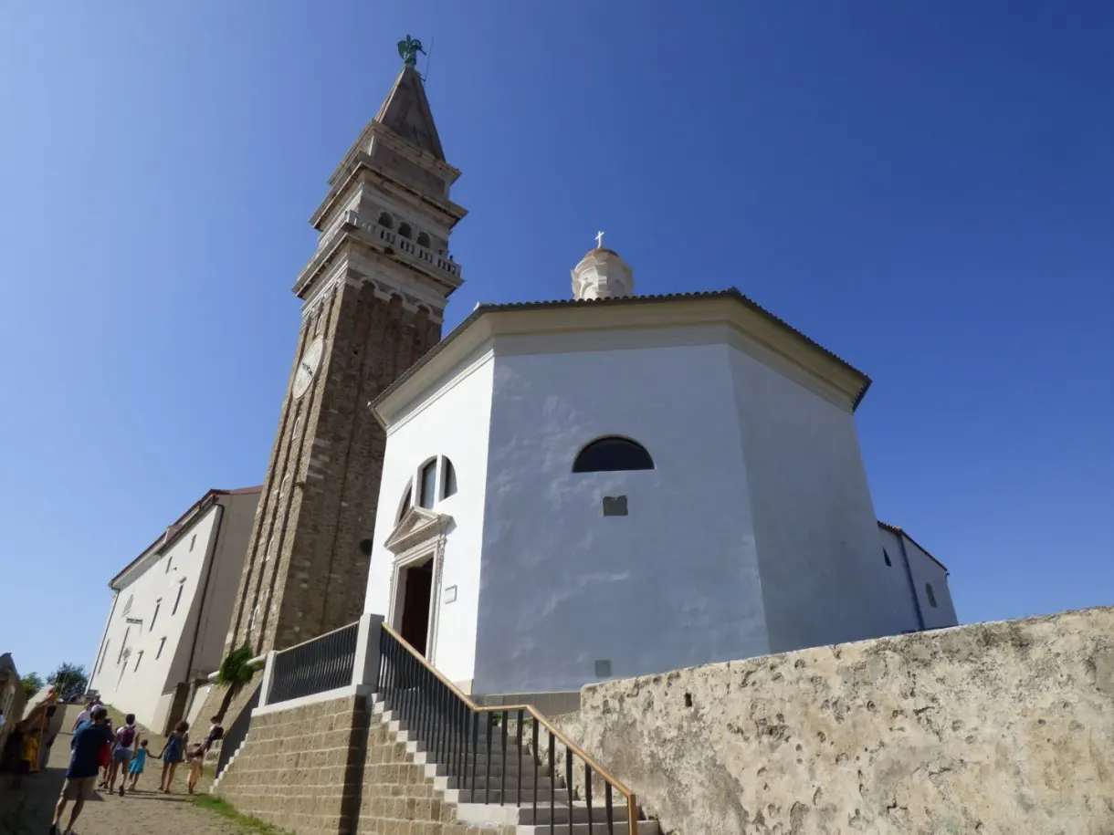 White church and tall campanile on their terrace