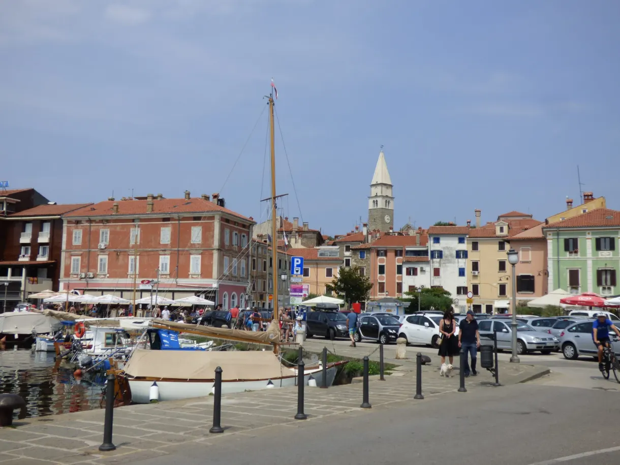 Lively quay of Izola in front of its slender bell tower