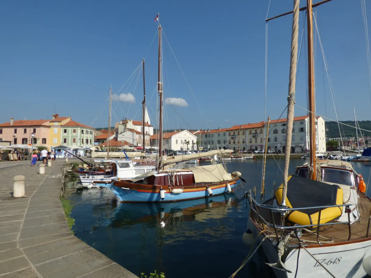 Old wooden sailing boats moored along the promenade