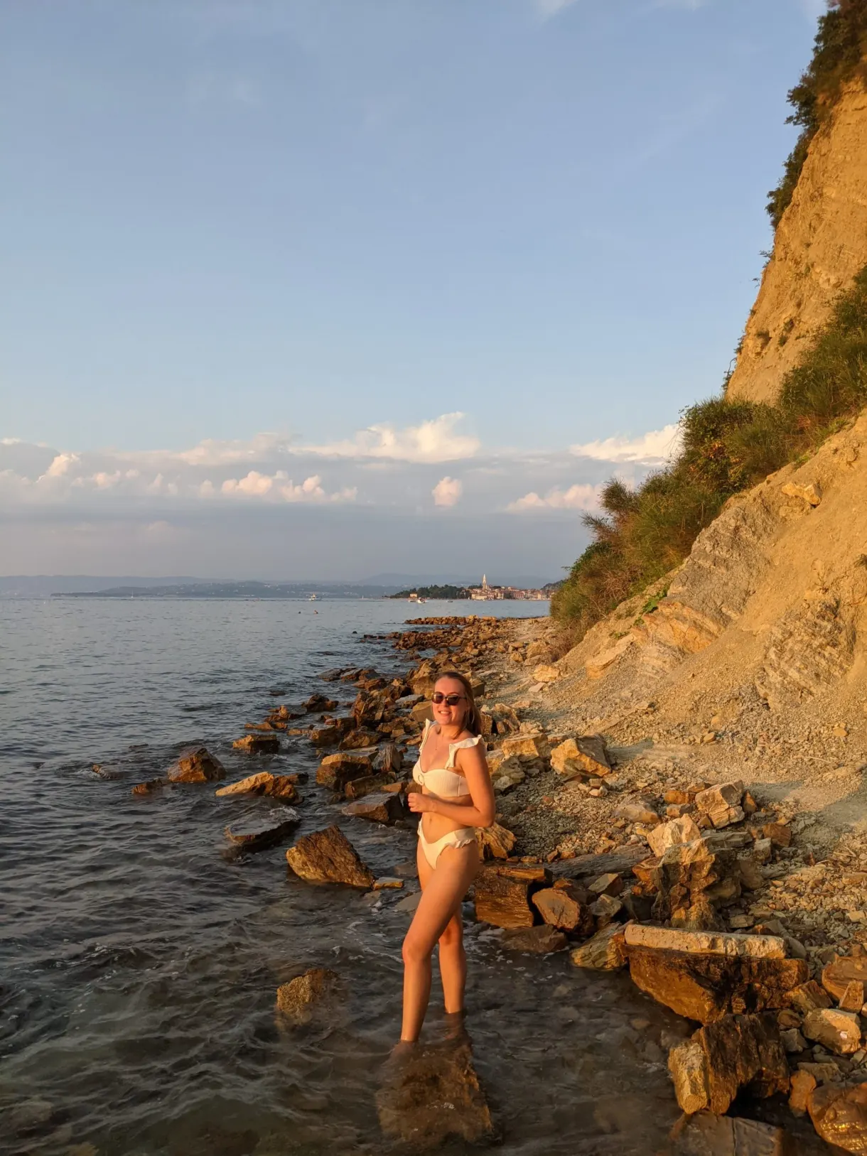 Bather at the foot of an ochre cliff and its rocks