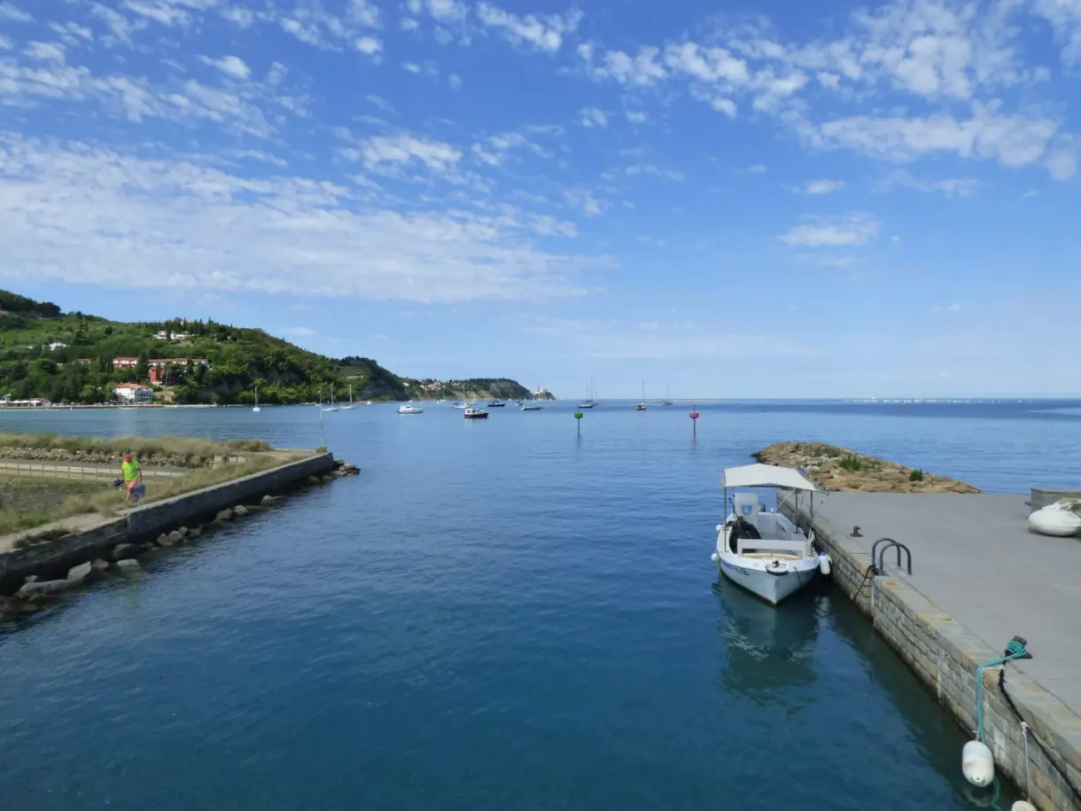 Boat moored at the pontoon at the entrance to the channel