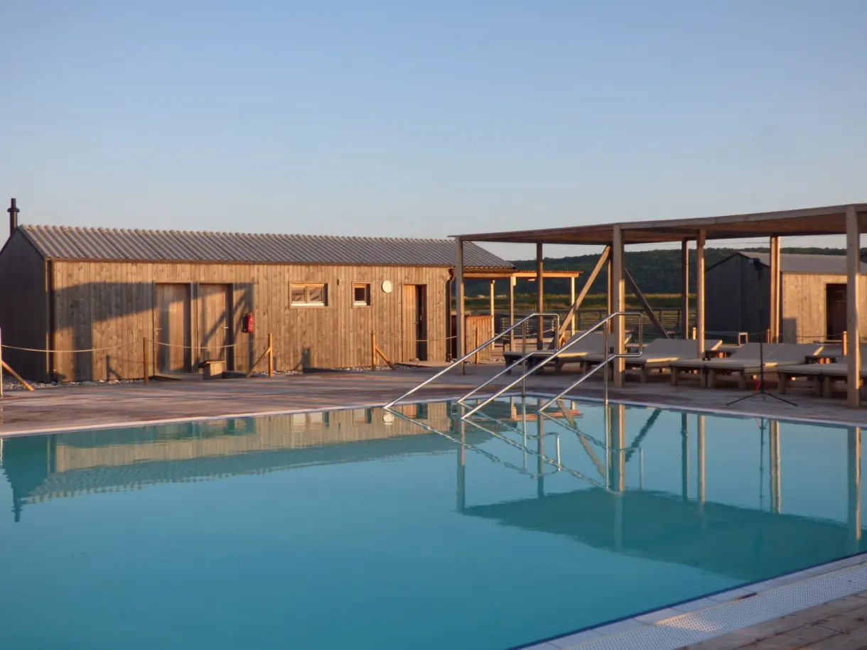 Pool steps and pergola on the wooden deck