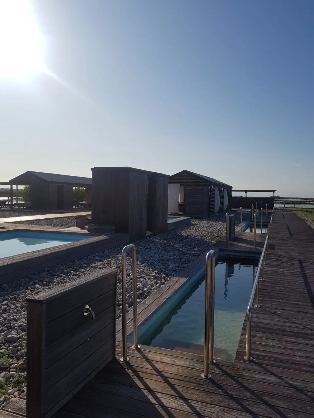 Dark cabins and small pools backlit