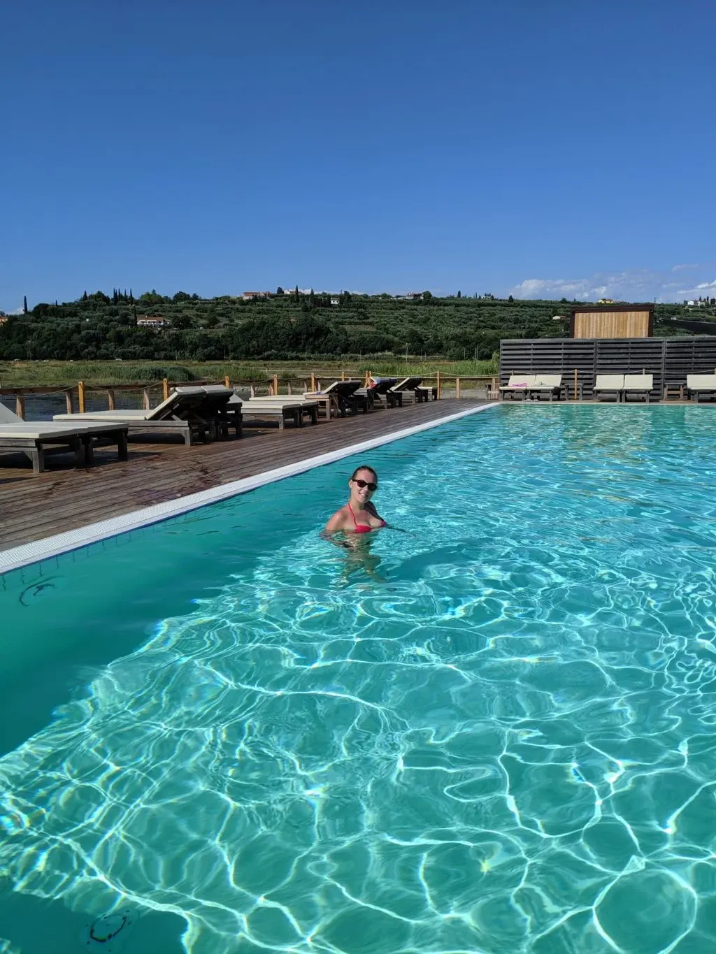 Bather in the turquoise water of the large pool