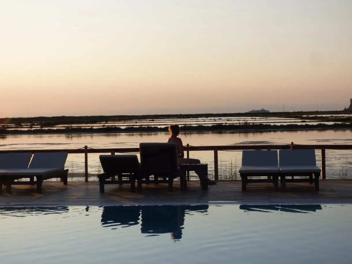 Deckchairs facing the salt pans in the golden light