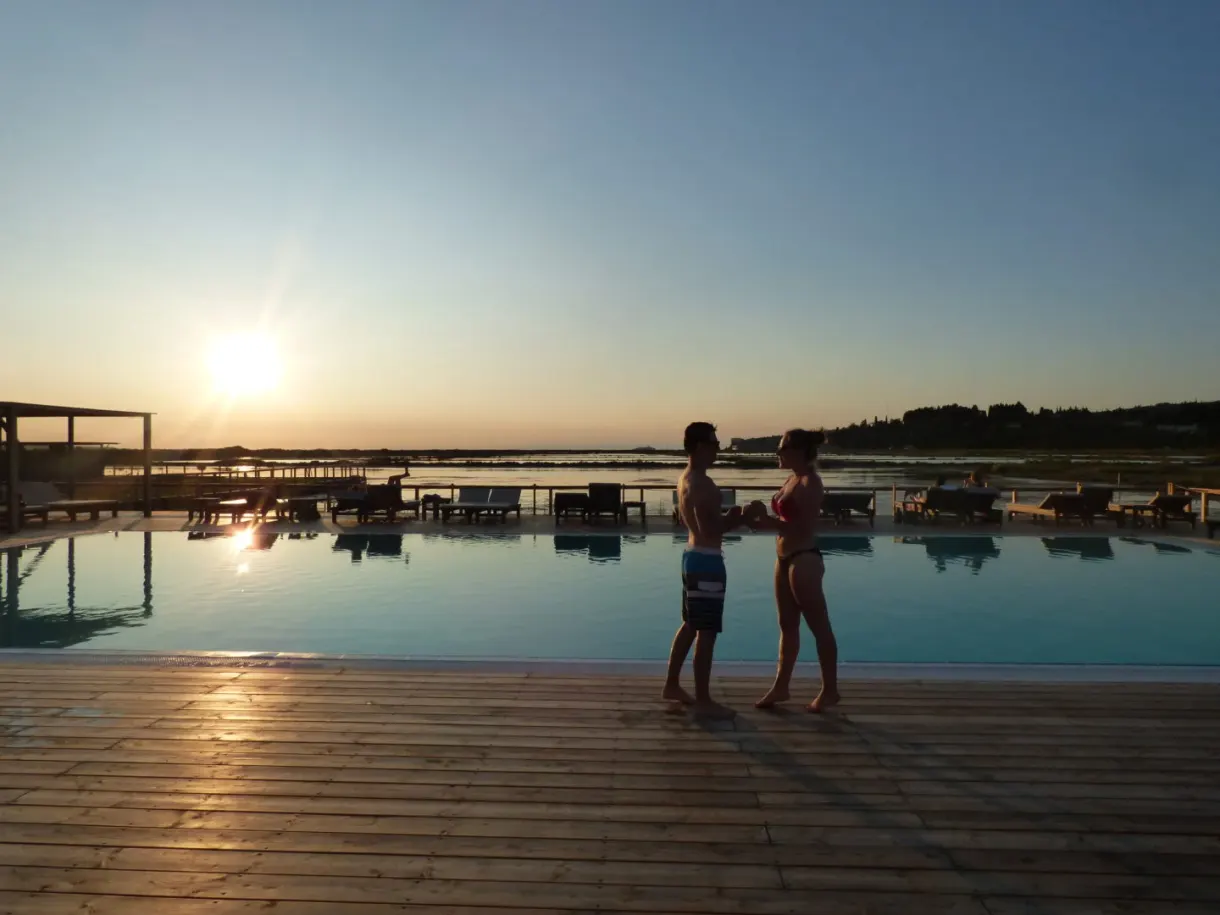 Couple at the edge of the infinity pool at dusk
