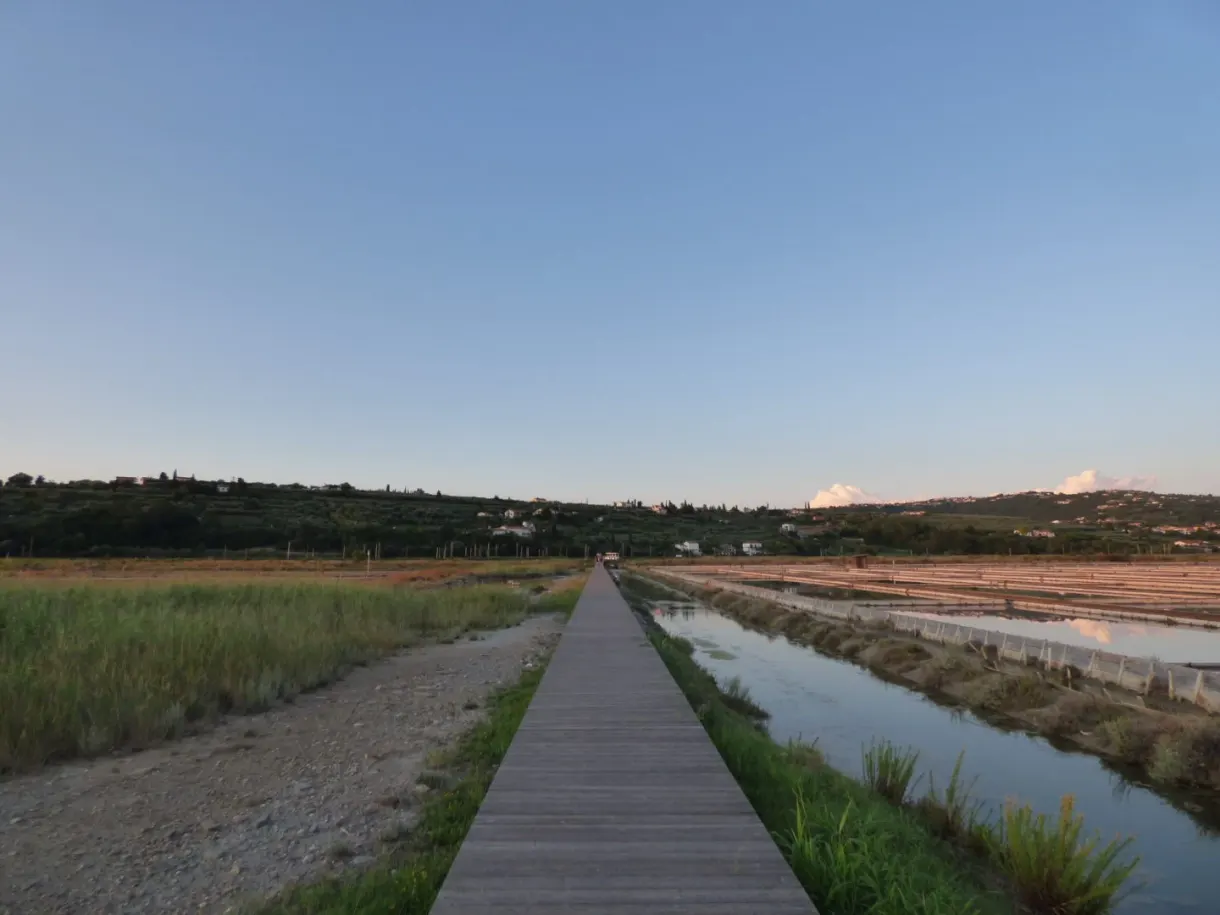 Dirt path winding between two channels of the salt pans