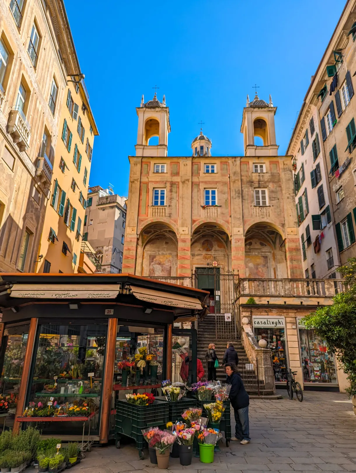 Flower kiosk in front of an arcaded palace on a Genoese square
