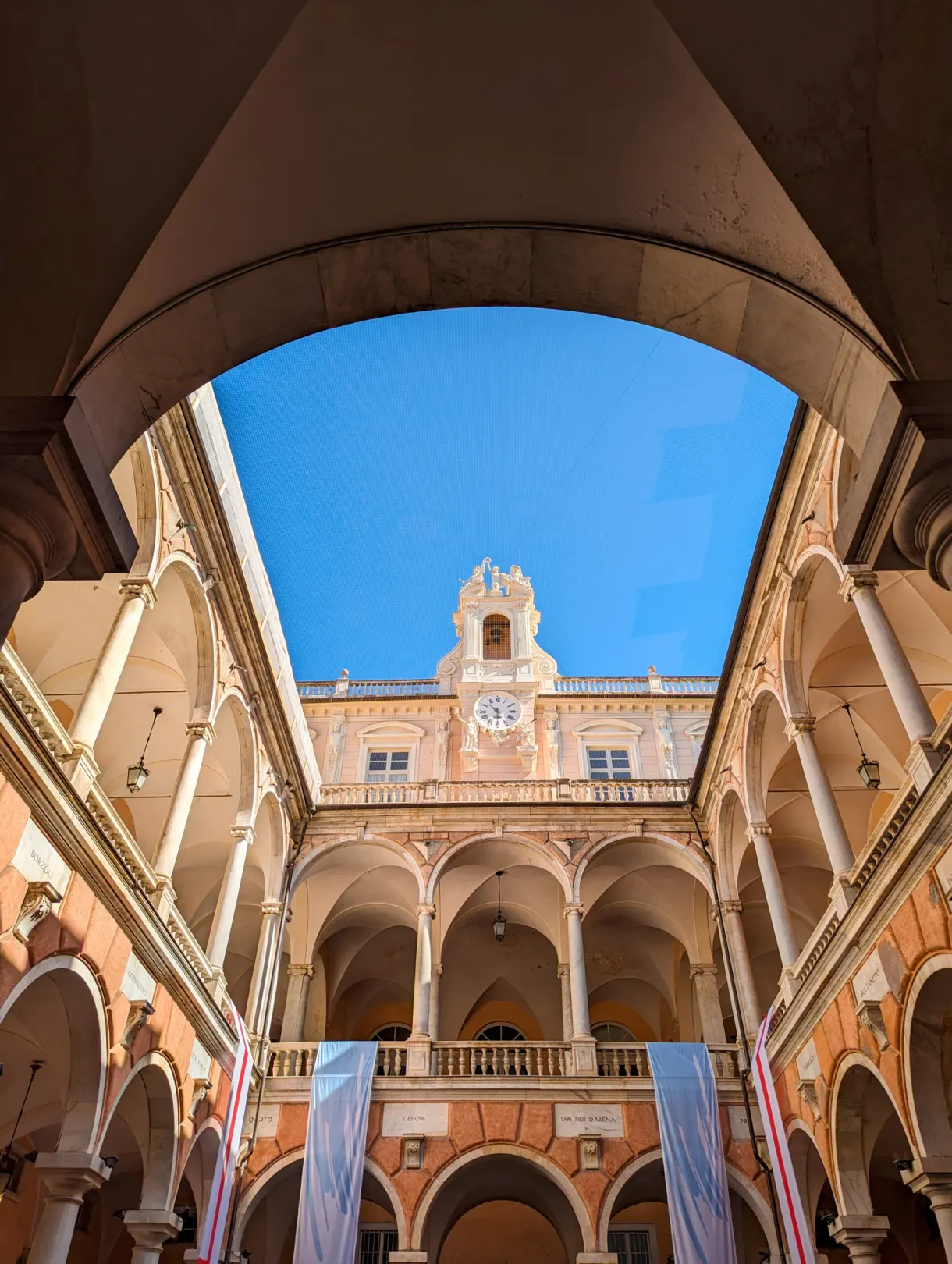 Arcaded courtyard of a Rolli palace seen through a large arch