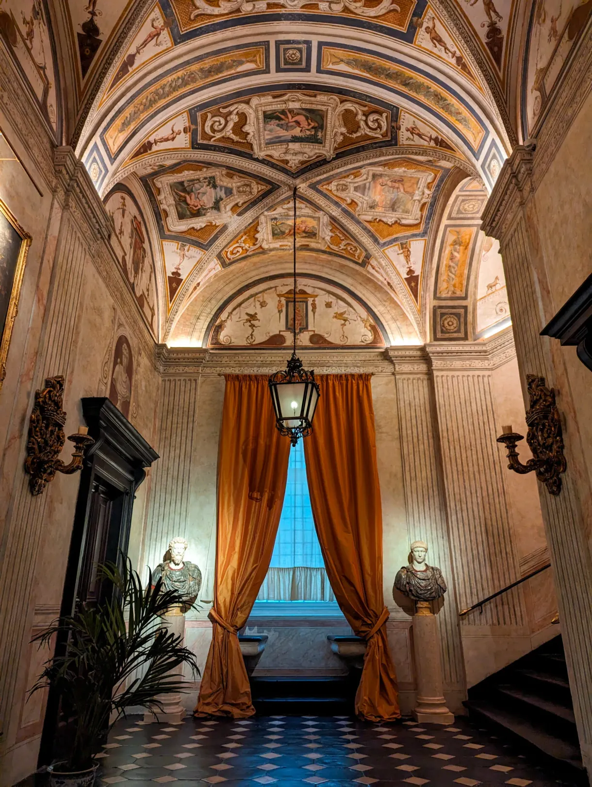 Palace vestibule with a painted ceiling, orange curtain and hanging lantern