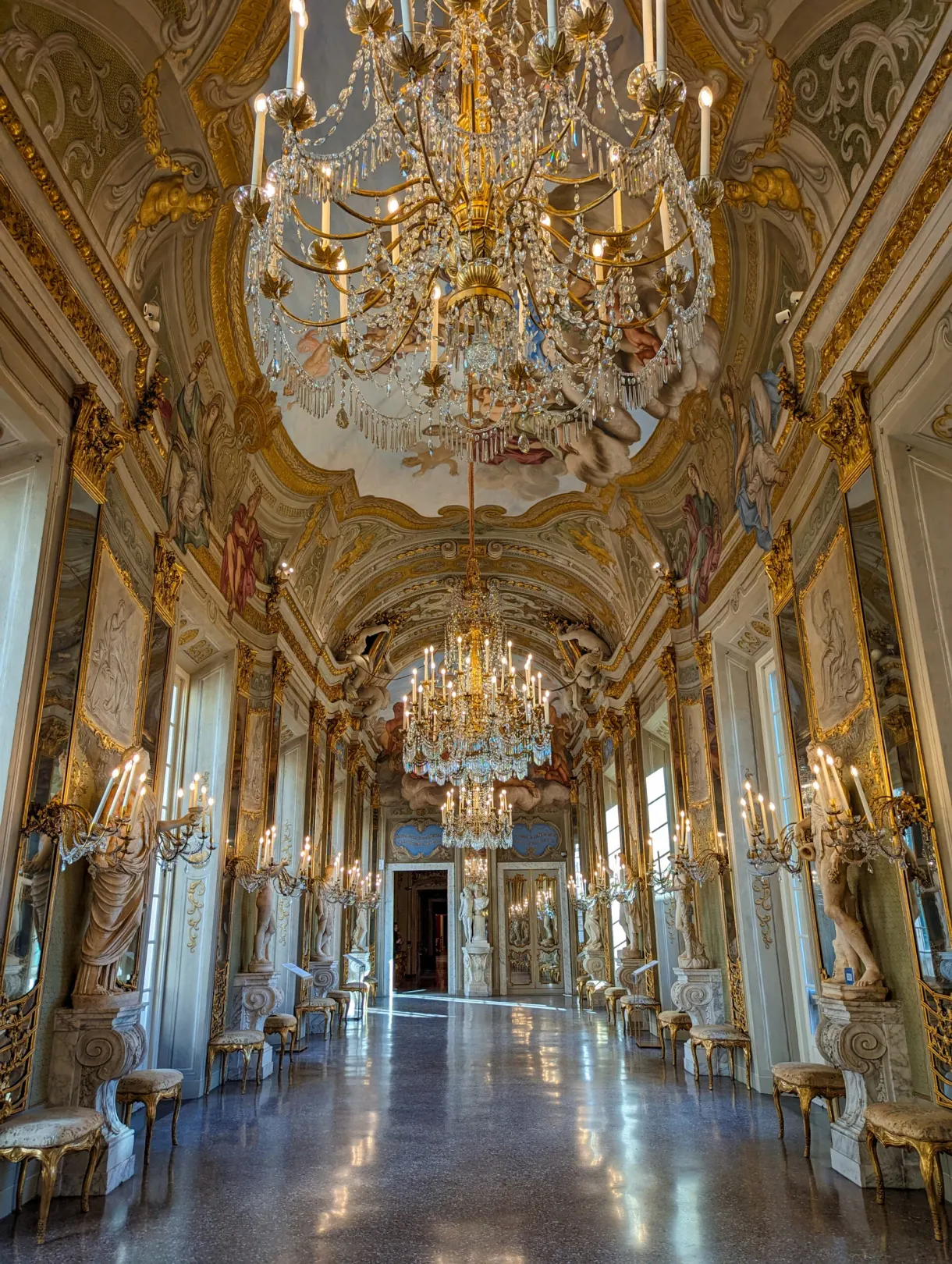 Hall of mirrors with crystal chandeliers and gilded walls