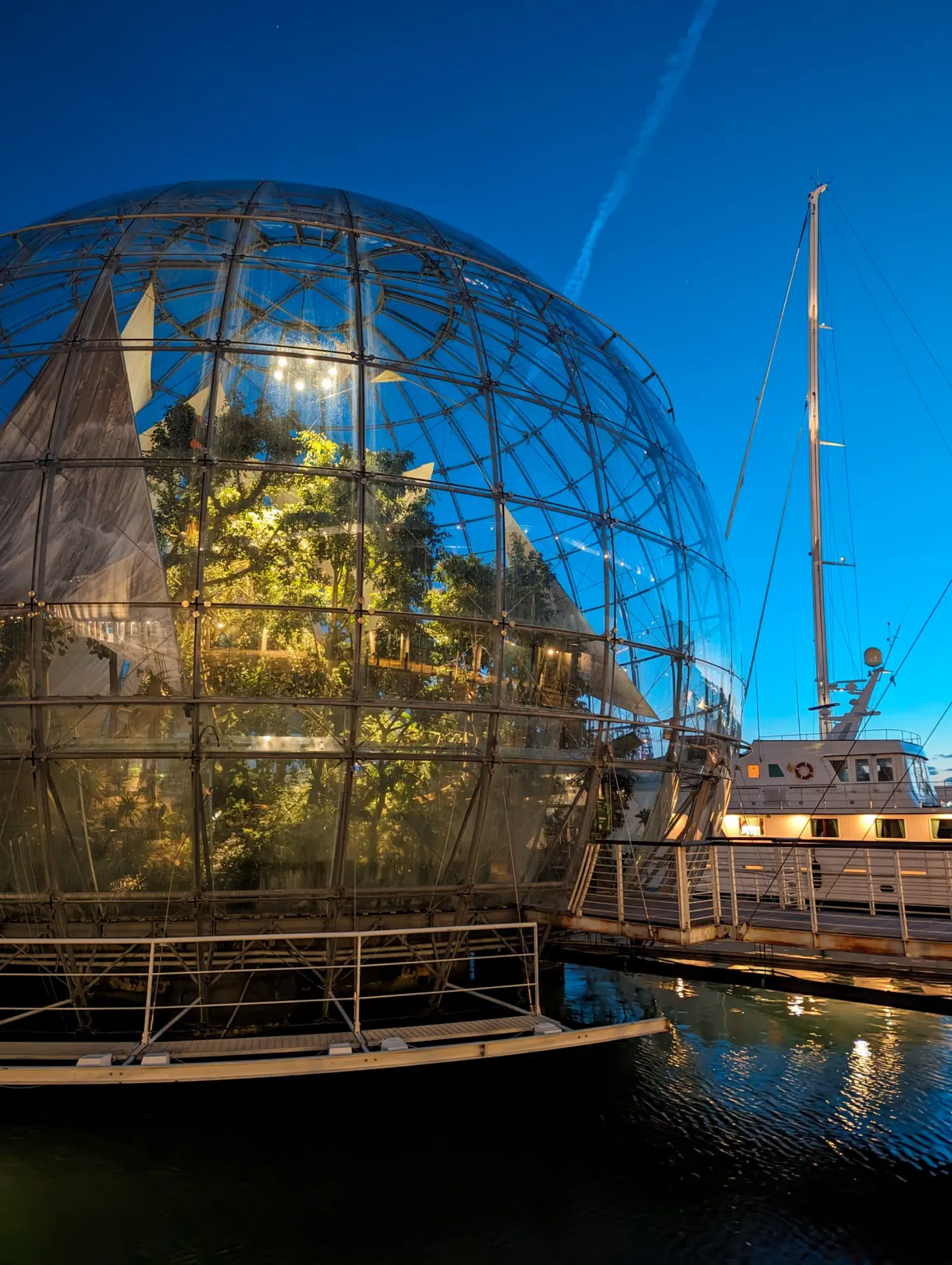 Planted glass sphere resting on the water of the harbour
