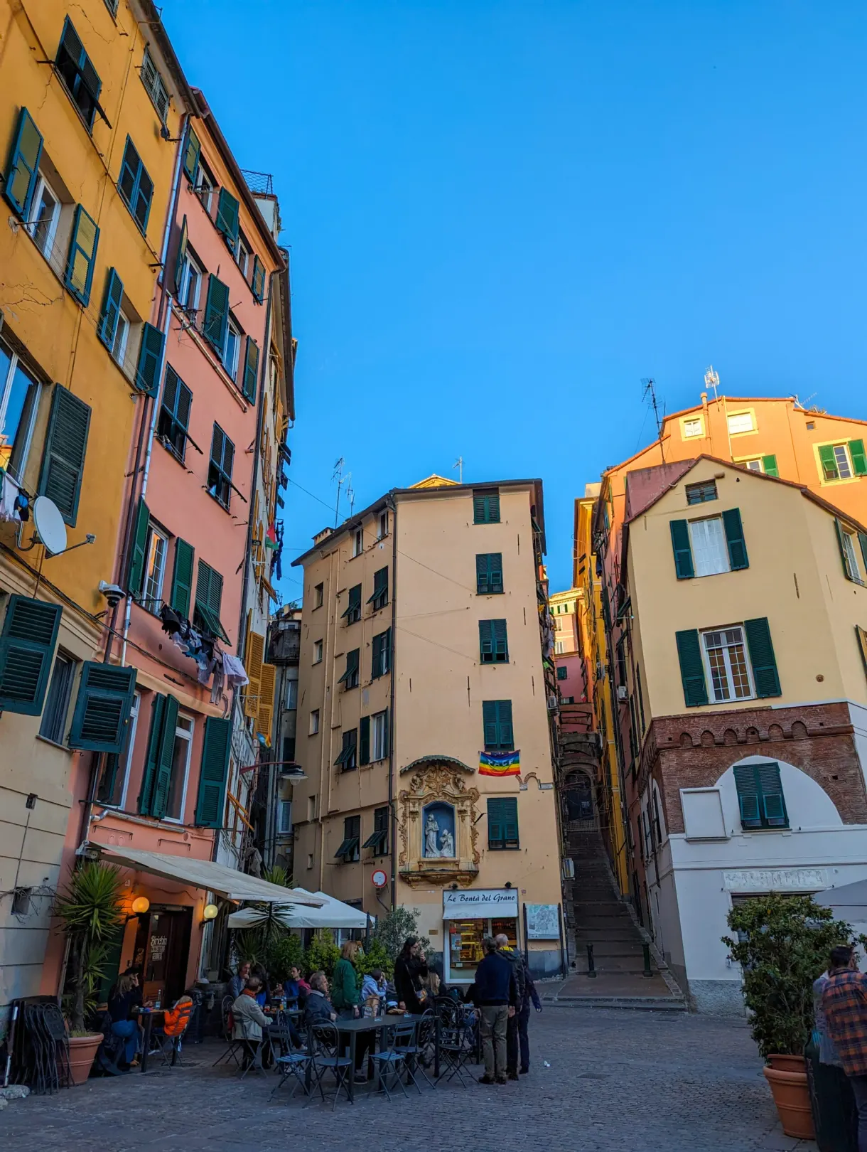 Cafe terraces on a small square with pastel facades