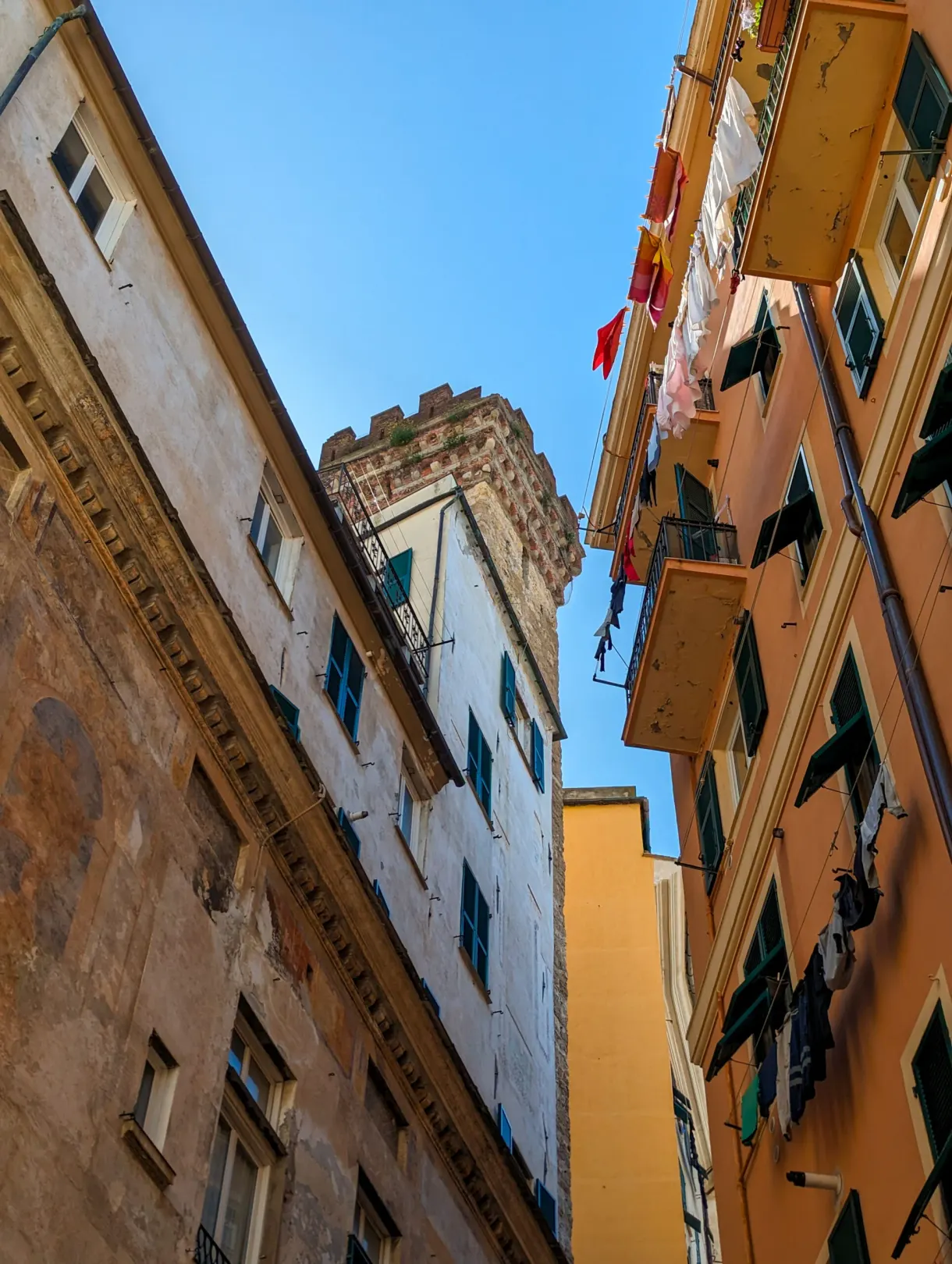 Very narrow lane and hanging washing seen from below