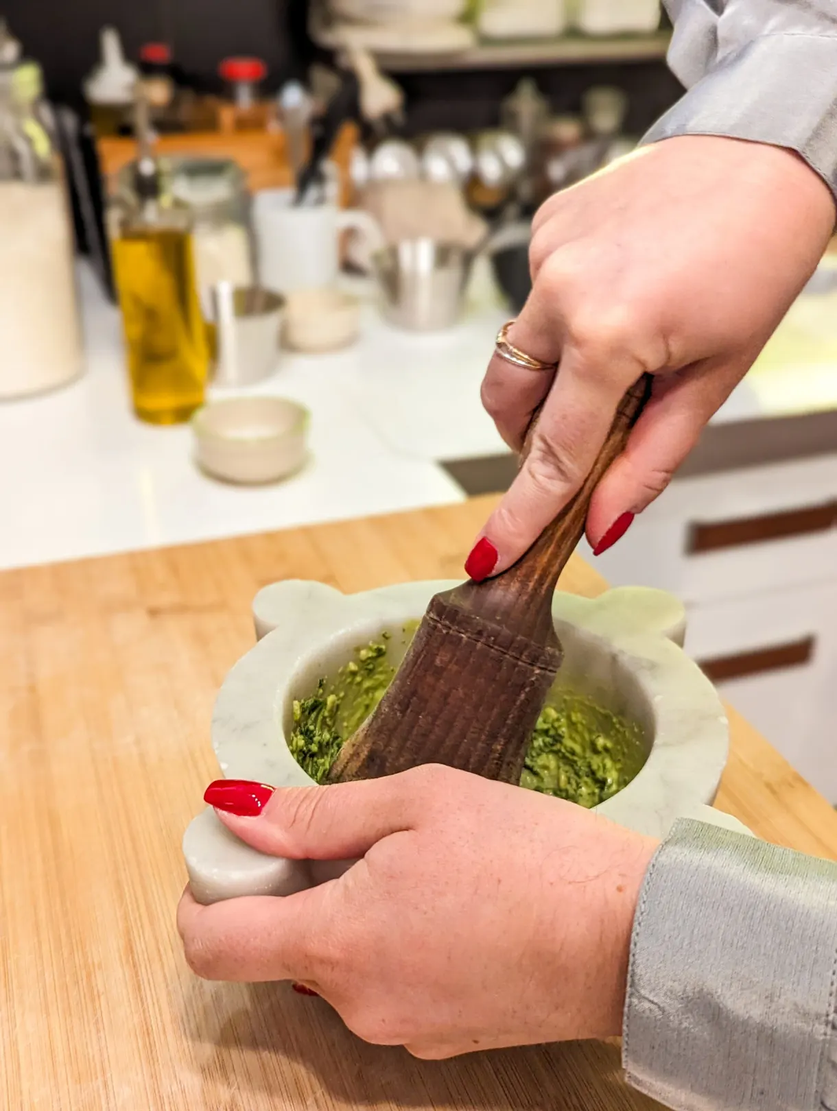 Basil crushed in a marble mortar to make the pesto