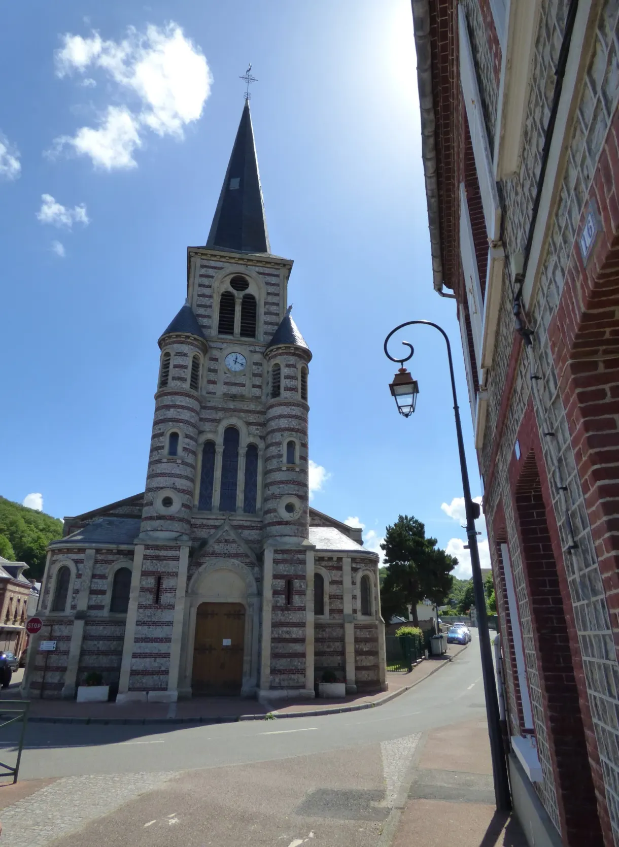 Slate bell tower of the church of Yport seen from a lane