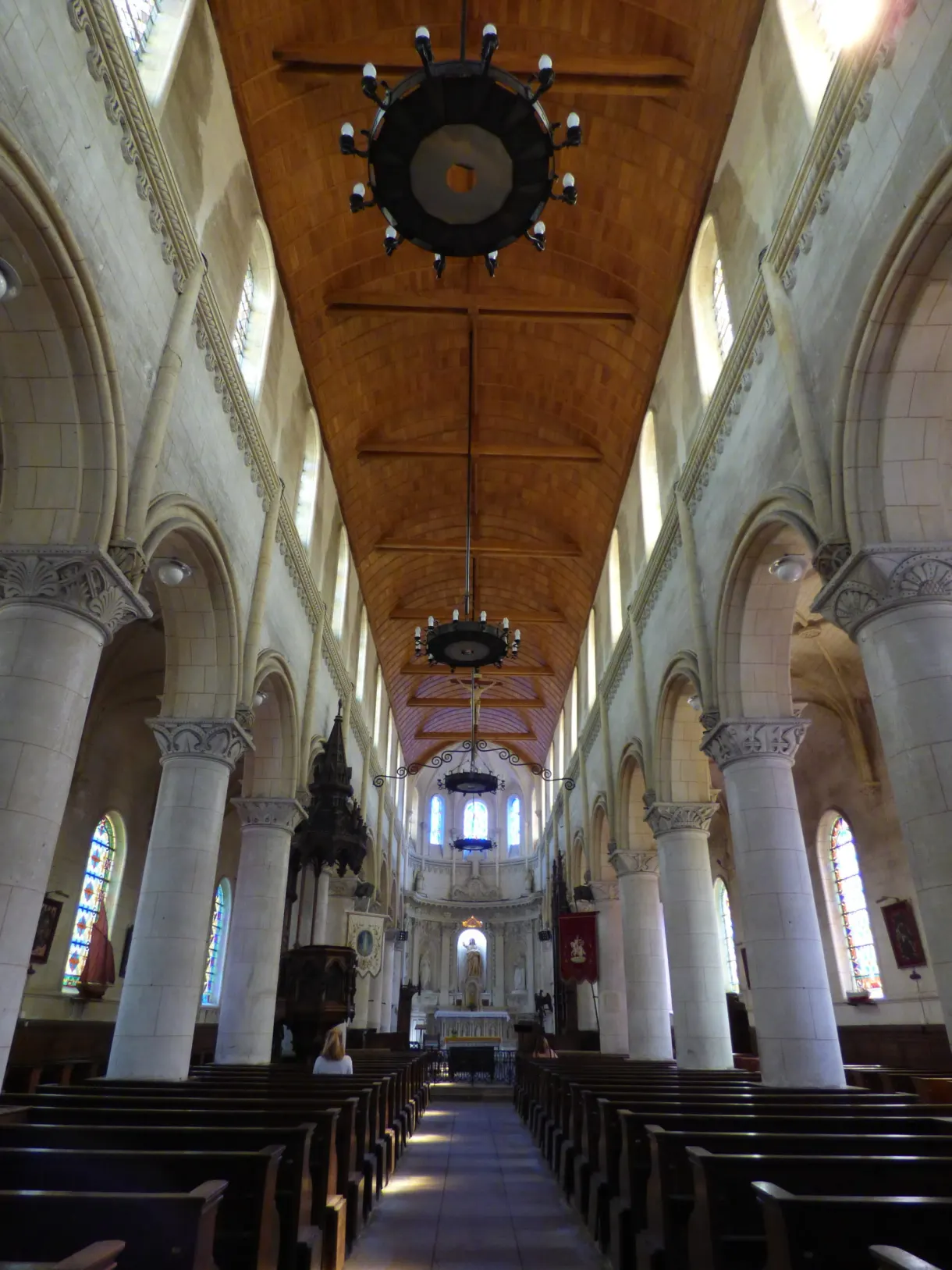 Nave with a wooden vault and a ship's wheel chandelier