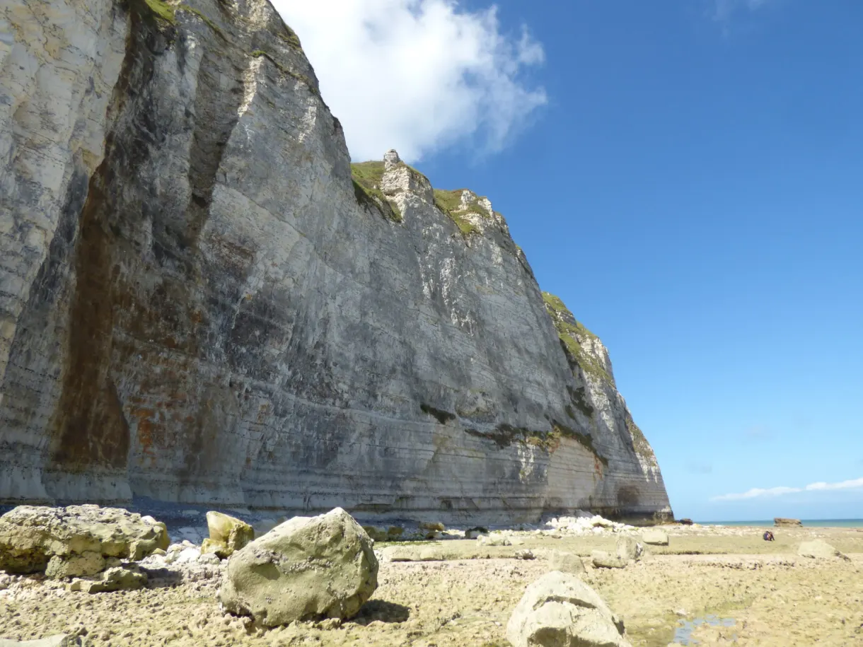 Striped wall of chalk and fallen blocks on the pebbles