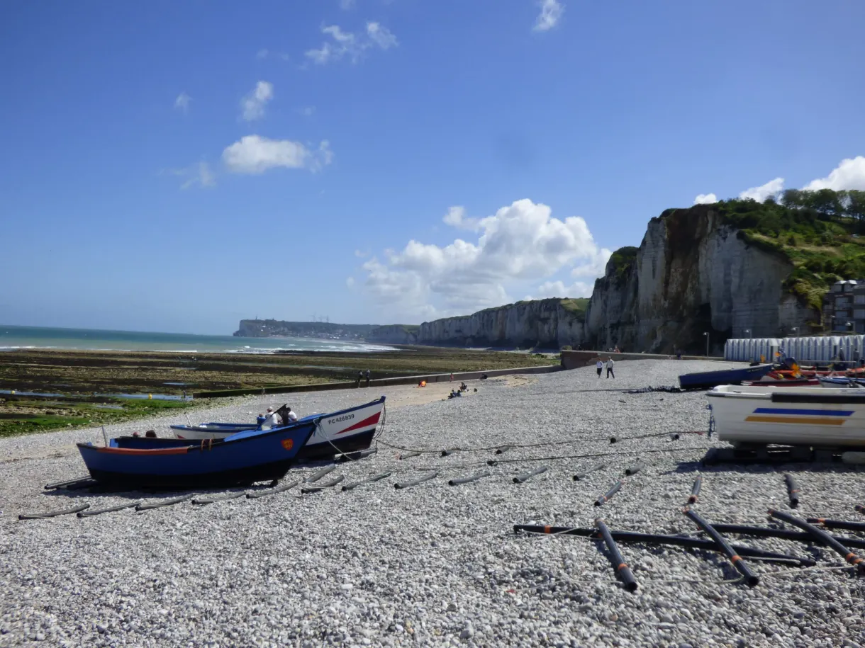 Fishing boats beached on the pebbles facing the cliffs of Yport