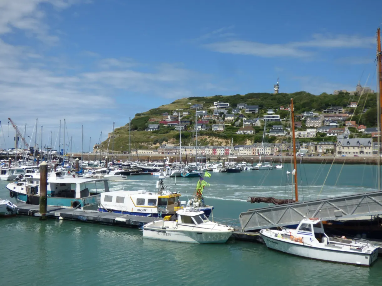 Sailing boats and vessels at the quay in the harbour of Fécamp