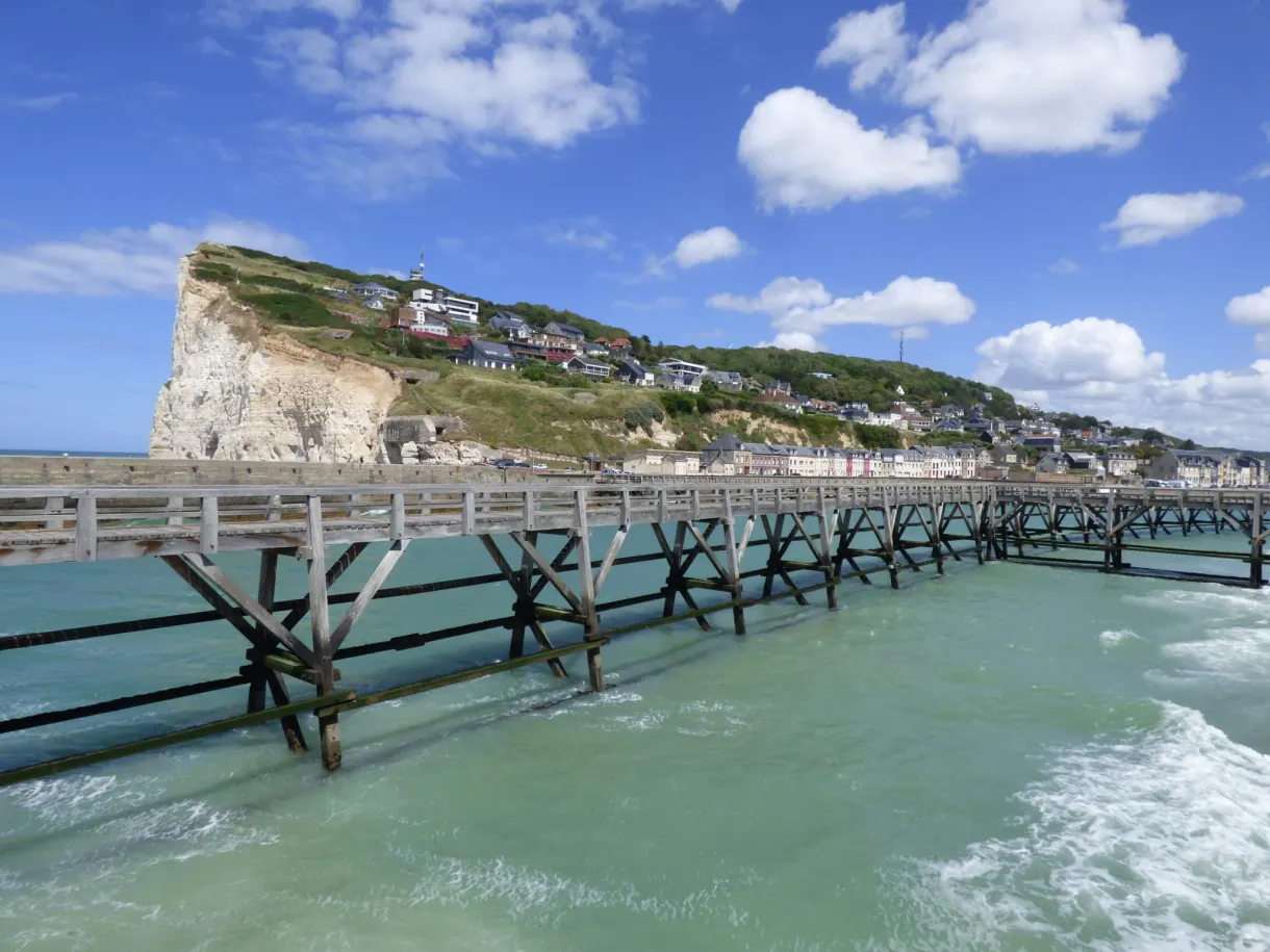 Old wooden jetty reaching out into turquoise water
