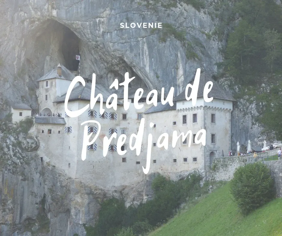 White castle set into the cliff, title Predjama castle