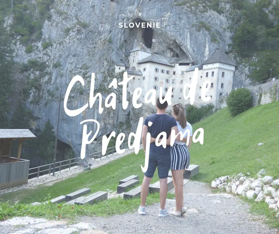 Couple seen from behind on the path to the castle, title Predjama castle