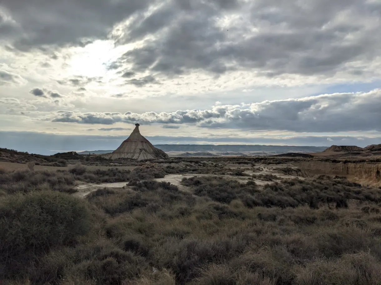 Rocky chimney in the distance under a sky of grey clouds