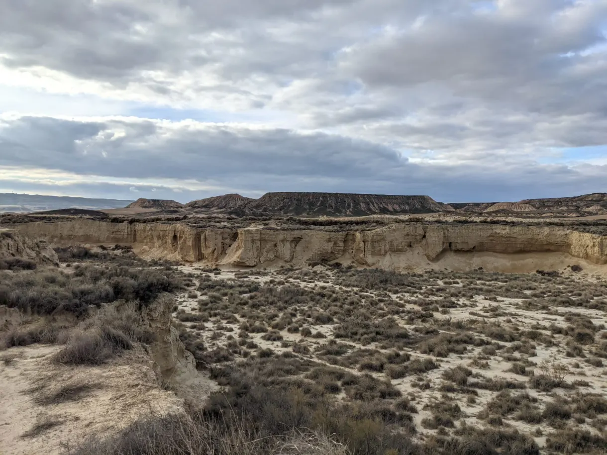 Flat-topped cliff overlooking a plain of low vegetation