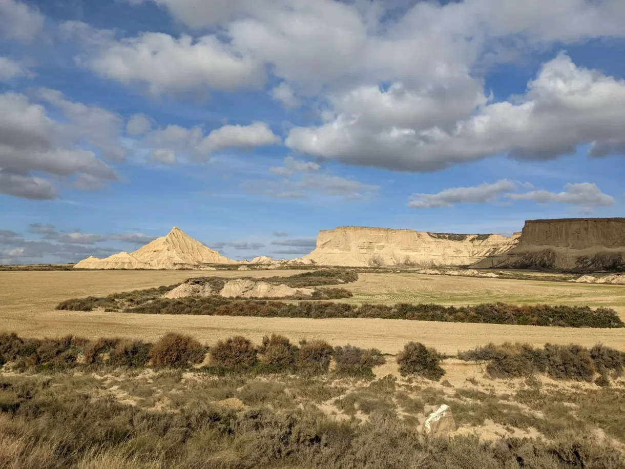 Cultivated fields at the foot of ochre mesas