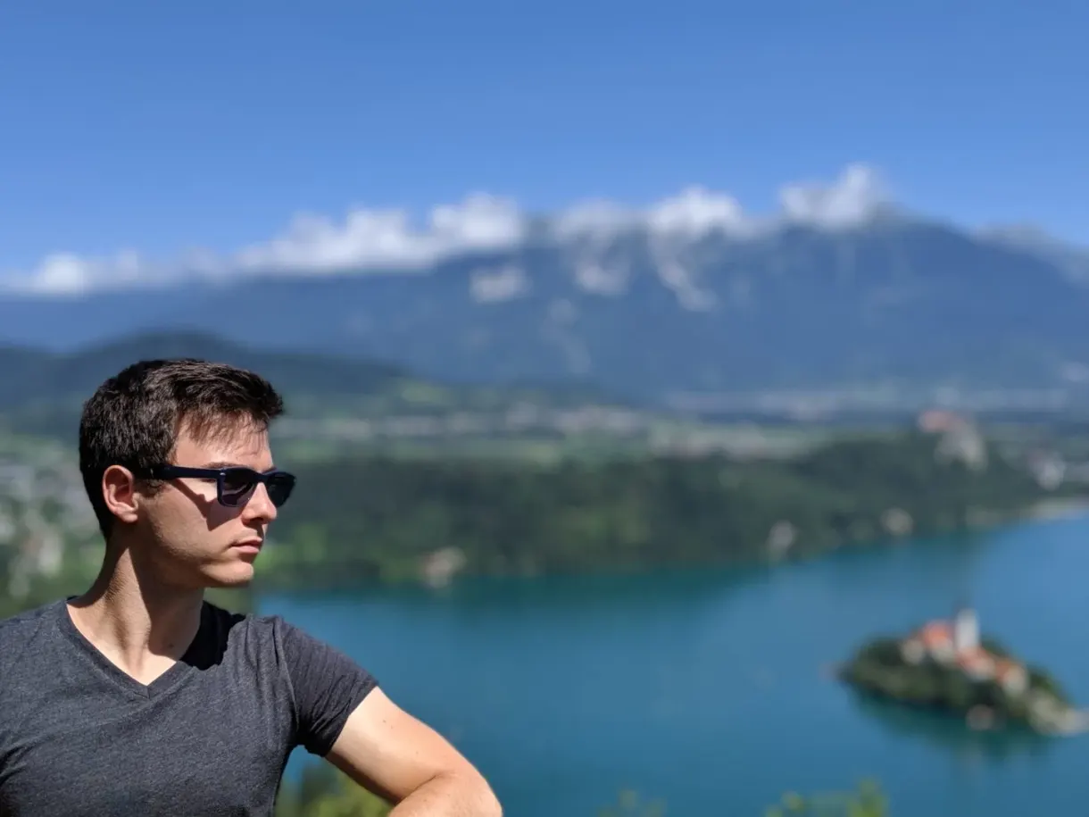Portrait in sunglasses, lake blurred behind