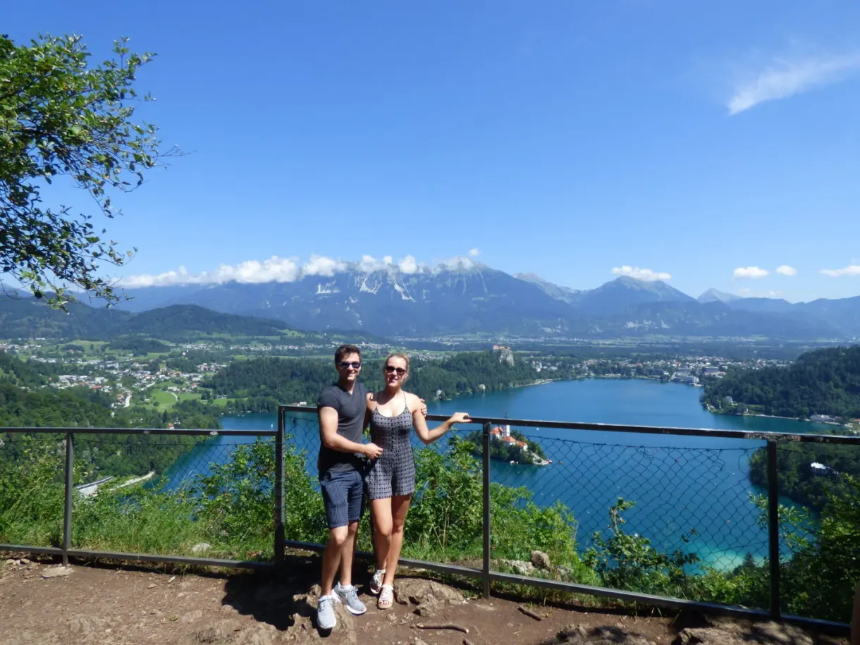 Couple at a fenced viewpoint overlooking the lake