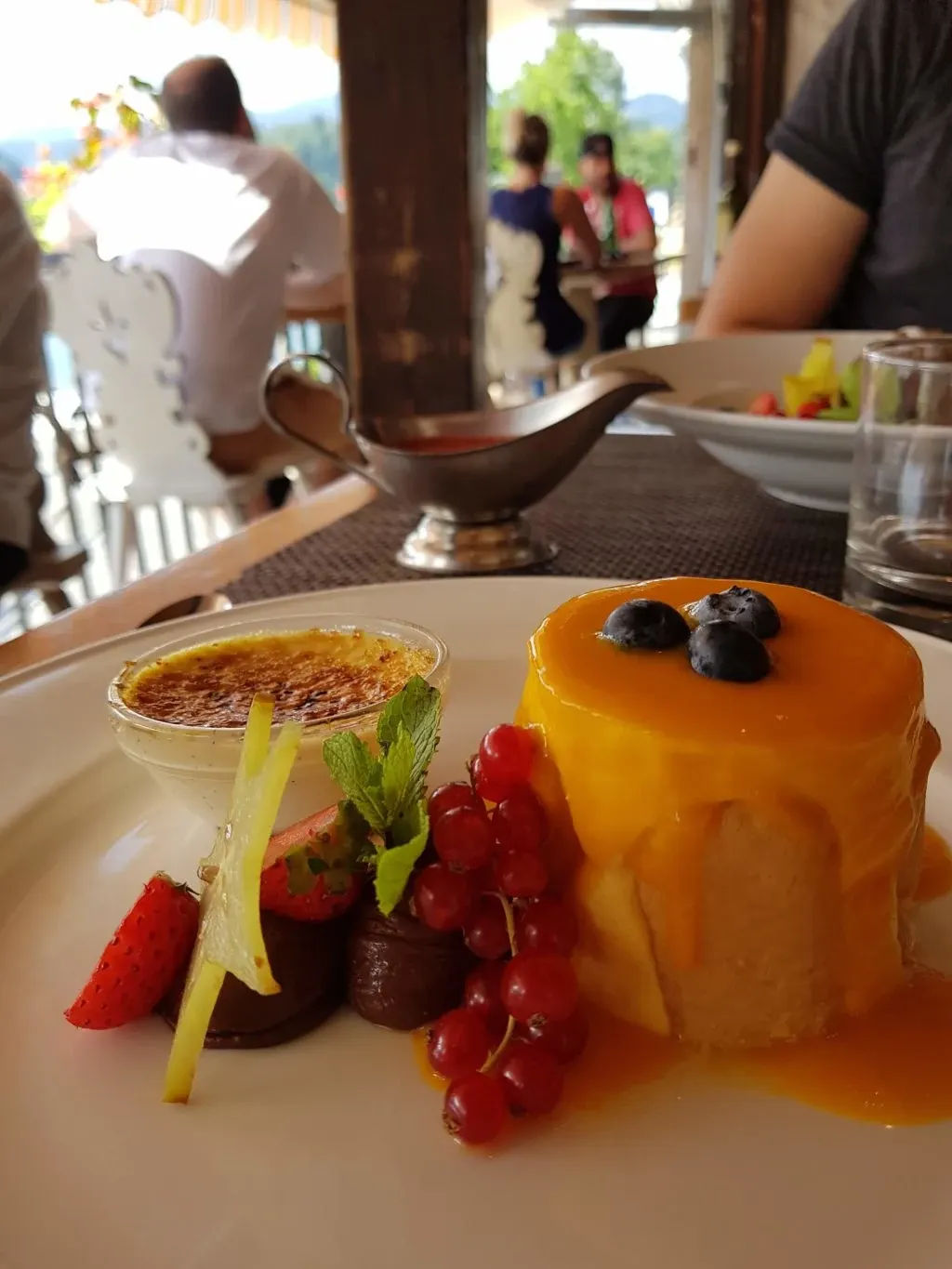 Plate of desserts, caramel flan and red berries
