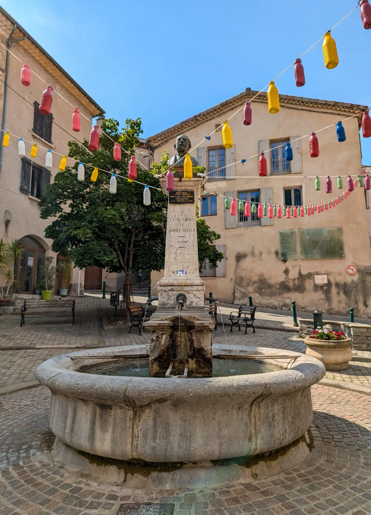 Round fountain and strings of bunting on the village square