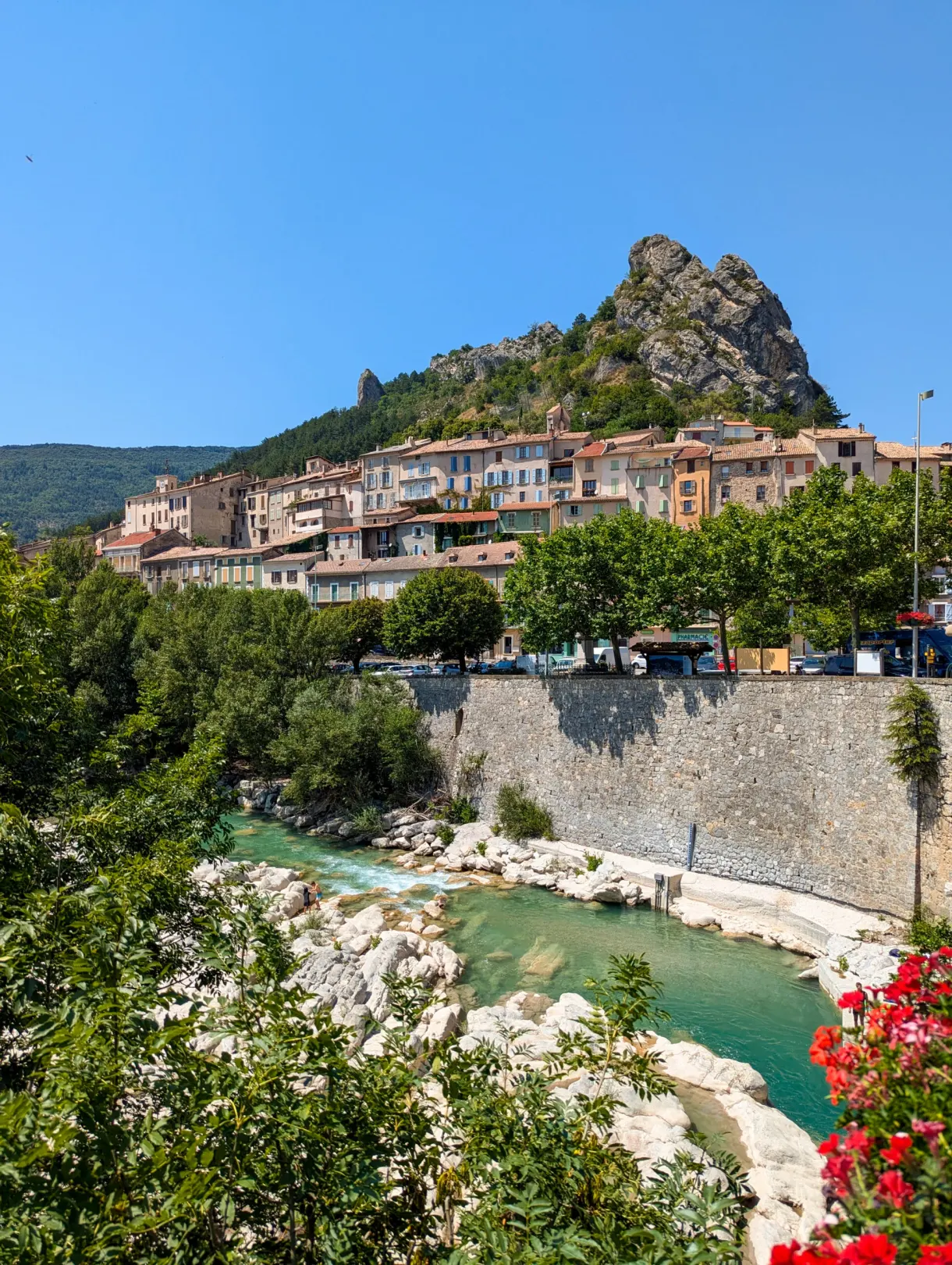 Village perched on its rock above a turquoise river